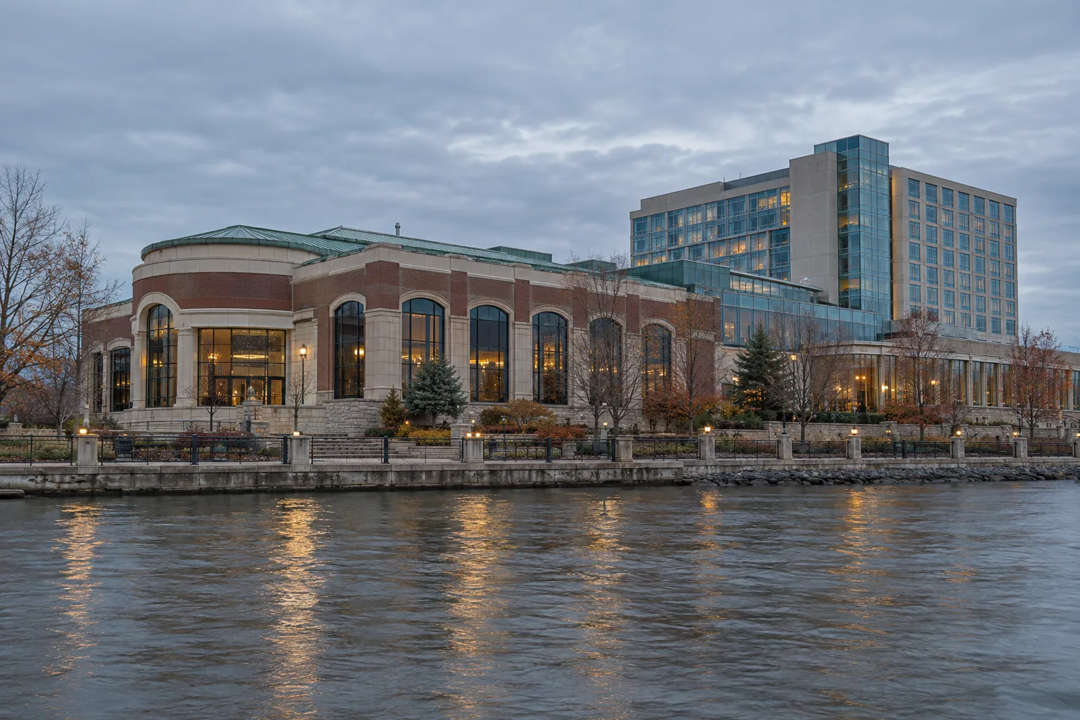 A historic casino resort exterior with low-rise wings, a garden court and a later glass hotel tower